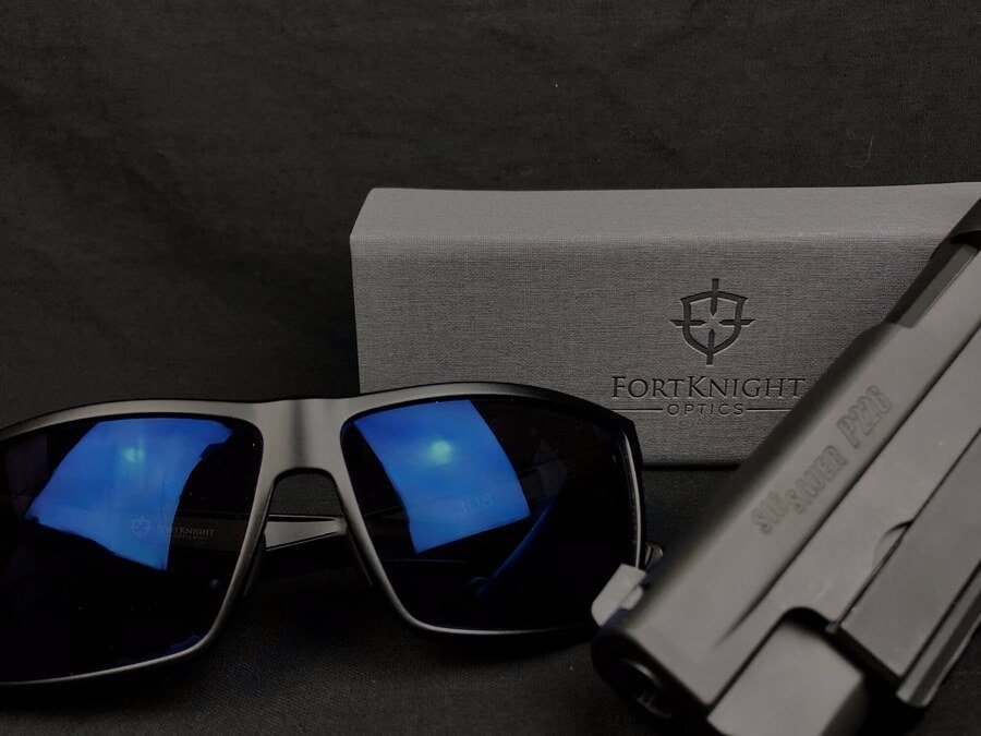 FortKnight Optics 308 Free Range polarized sunglasses with FrontSight HD blue mirror lenses beside the branded box and a SIG Sauer P226.